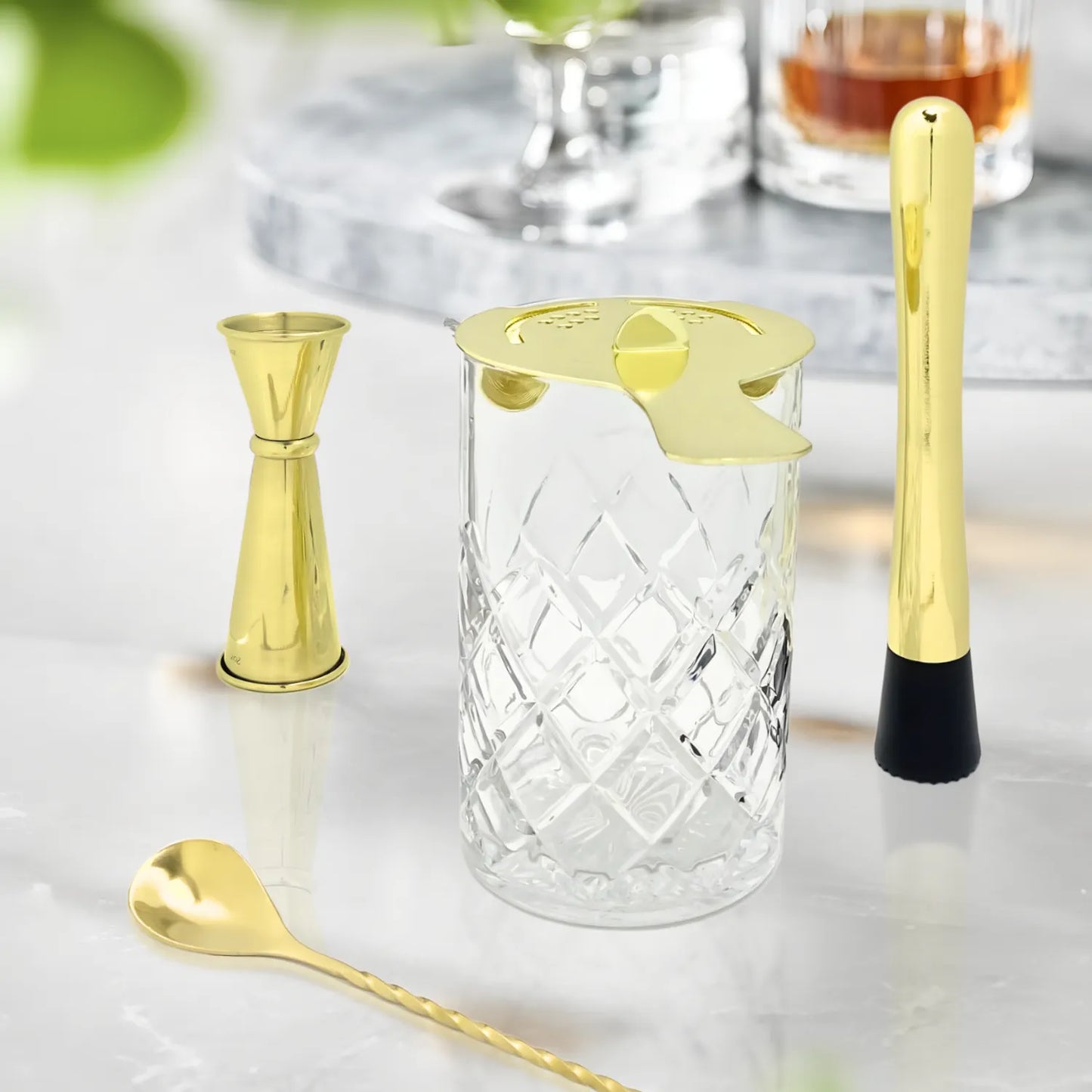 gold mixing glass cocktail set on table