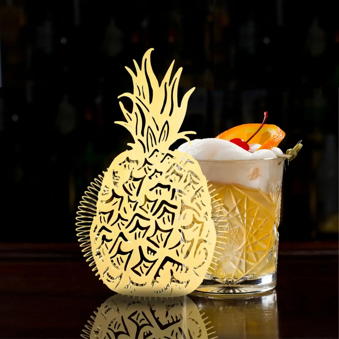 gold pineapple strainer on table