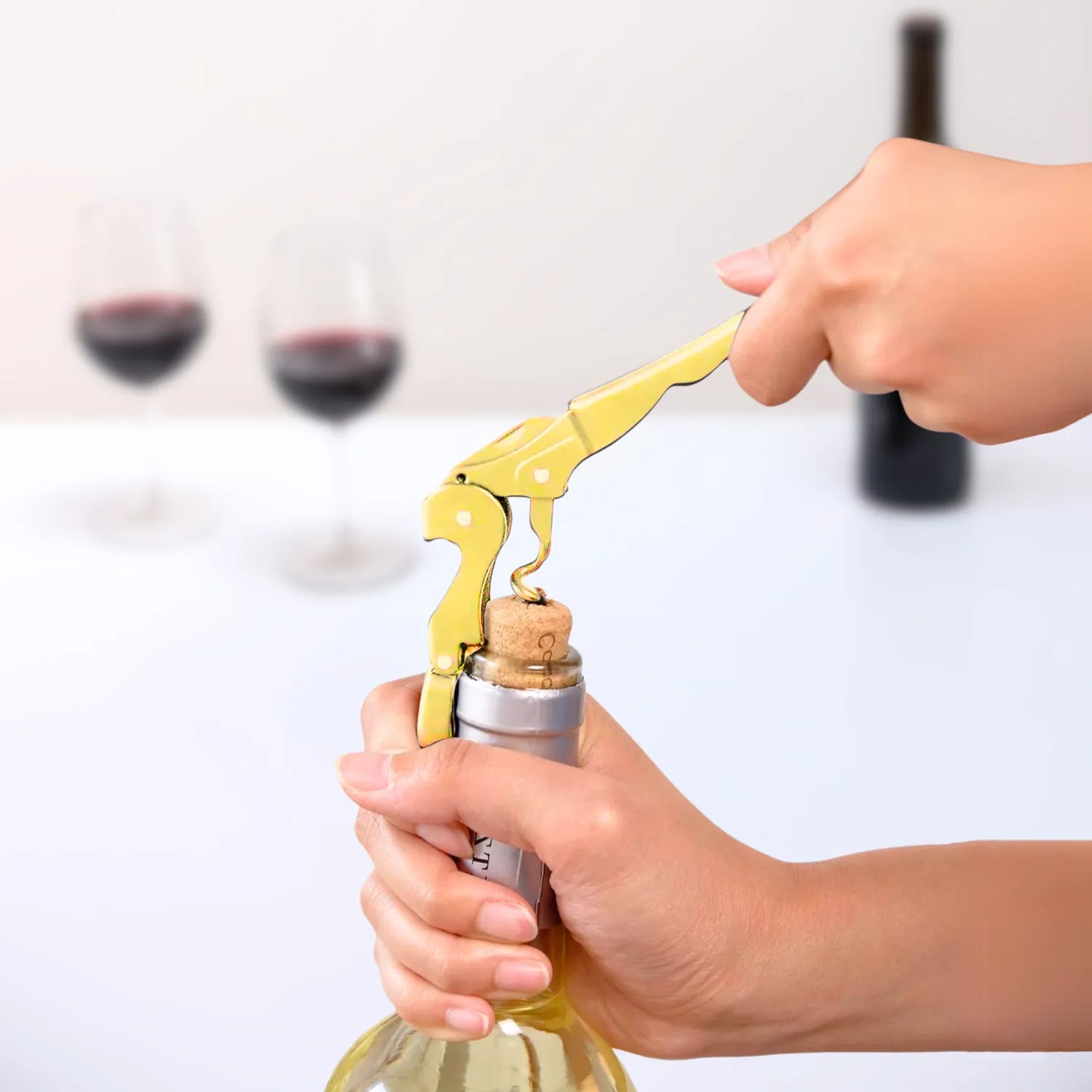 gold wine key in use